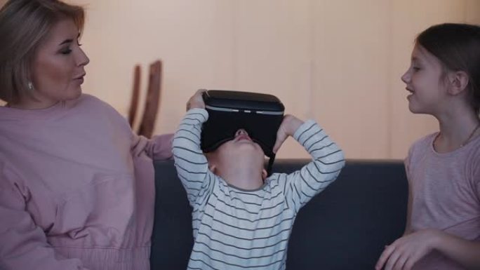 开朗的儿子正在佩戴用于vr游戏的新型3d虚拟现实设备
