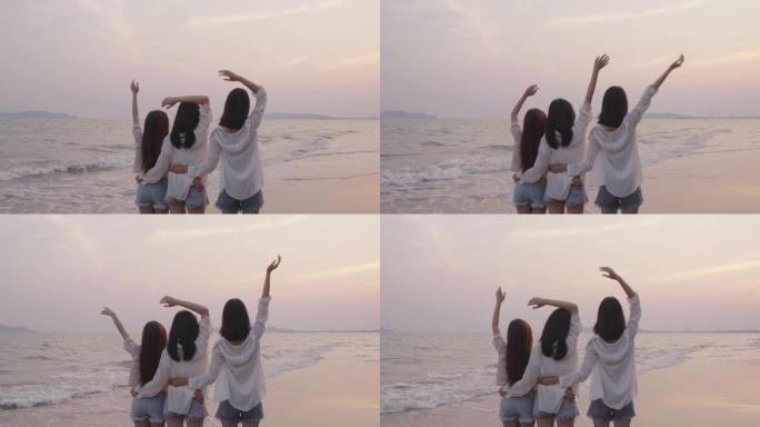 微笑快乐的亚洲朋友一群年轻女性在海滩上海边暑假日落剪影黄昏假期旅游享受生活周末活动人们的生活方式，慢
