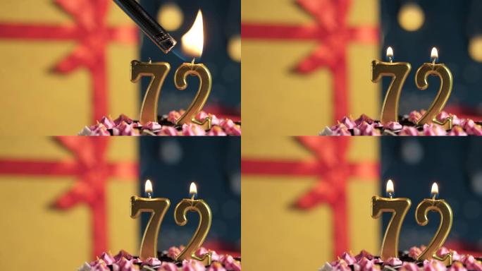 生日蛋糕编号72点灯燃烧的金色蜡烛，蓝色背景礼物黄色盒子用红丝带绑起来。特写和慢动作