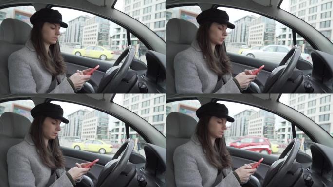 戴着黑帽子的年轻女子使用智能手机坐在驾驶员座位上