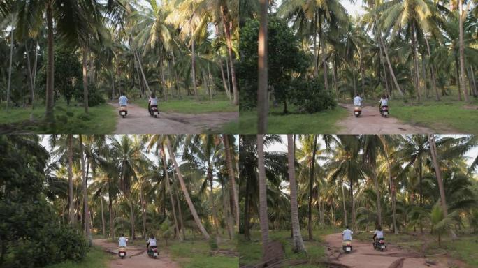 两个摩托车手，一个男孩和一个女孩骑着自行车穿越丛林。椰子种植园的乡村道路。惊人的冒险。仙女岛
