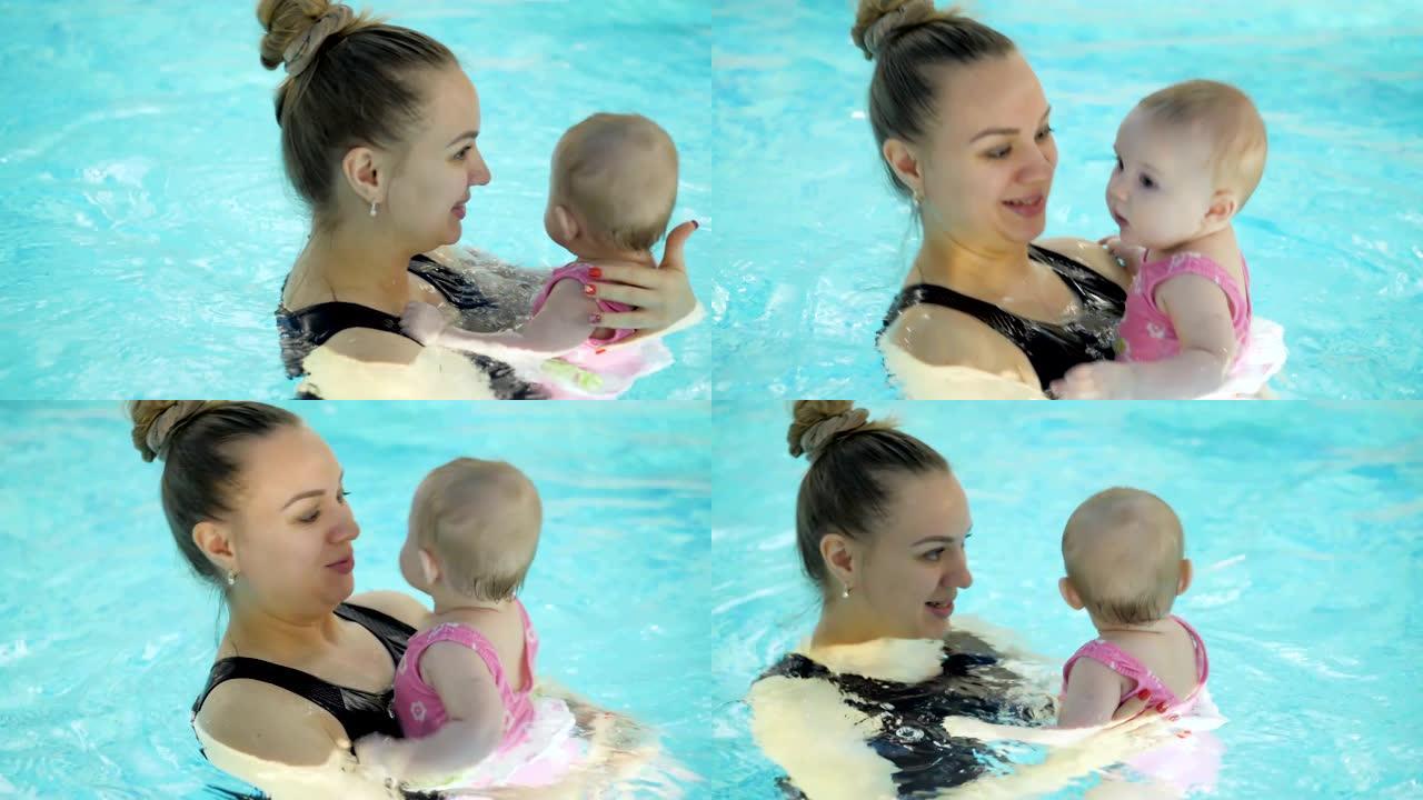 游泳课。母亲在游泳池教新生婴儿游泳