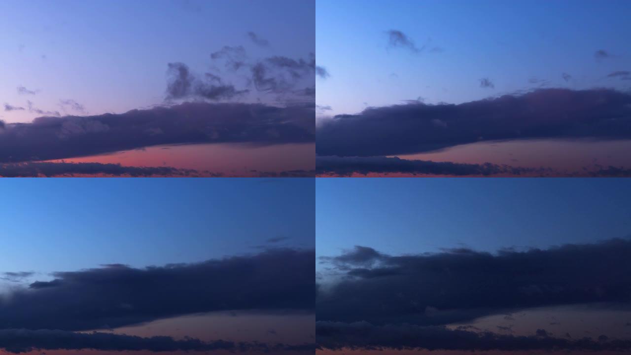 日落后天空的时间流逝，浓密的灰色云彩将天空划分为两种不同颜色的区域: 蓝色和紫色