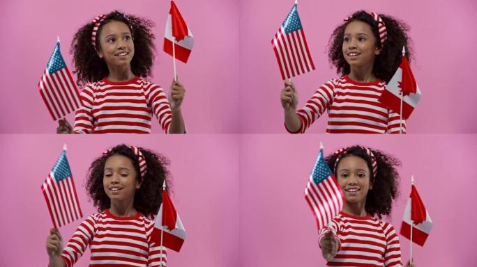 带有美国和加拿大国旗的非裔美国孩子被隔离在粉红色上
