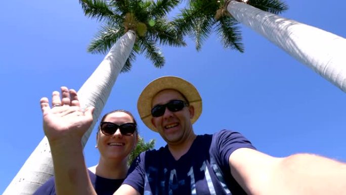 幸福的夫妇在热带度假胜地自拍并以4k慢动作60fps发送问候