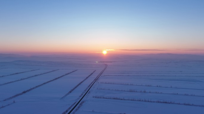 航拍4K东北垦区田野雪景落日