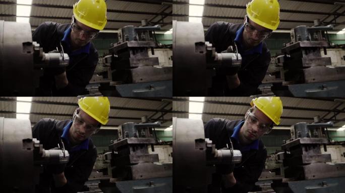 工程师工人戴上黄色安全帽，使用工具检查和维修工厂中的机器状况，以准备生产。职业和意外保险概念