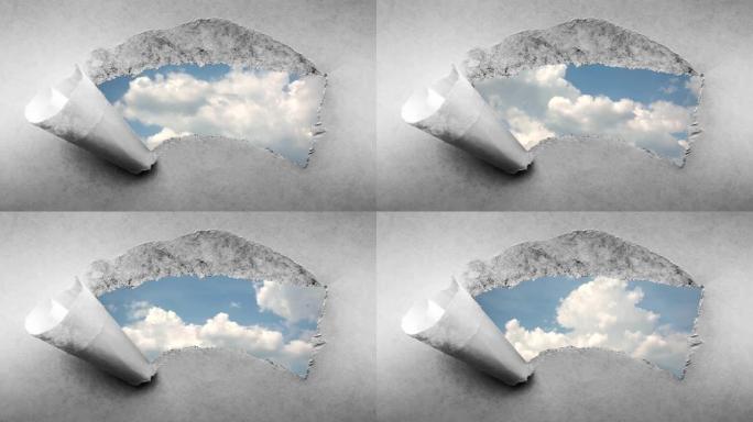 创意4k时间圈视频，在蓝天中快速移动的云，可以通过旧复古垃圾老式纸的边缘撕裂的孔看到。