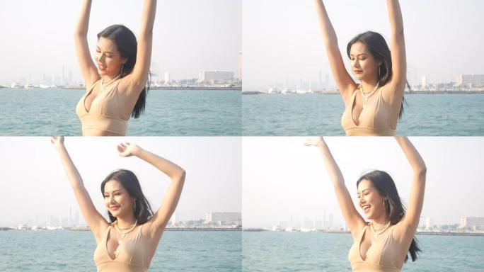 美丽的幸福年轻亚洲妇女在夏季周末乘船海滩旅行。