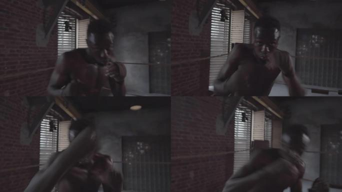 肌肉发达的美国黑人拳击手影子拳击在肮脏的健身房
