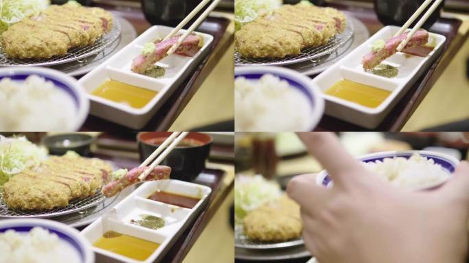 吃日本食物的年轻亚洲女性: 炸猪排在蒸日本米饭上，桌上有咖喱