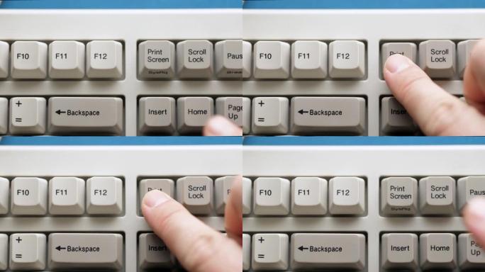 男性手指按下白色键盘上的打印屏幕按钮。慢动作和宏观视图