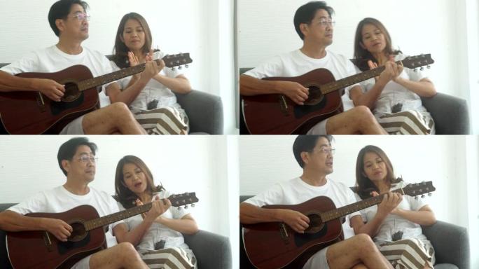 夫妻弹吉他，一起快乐地唱歌。