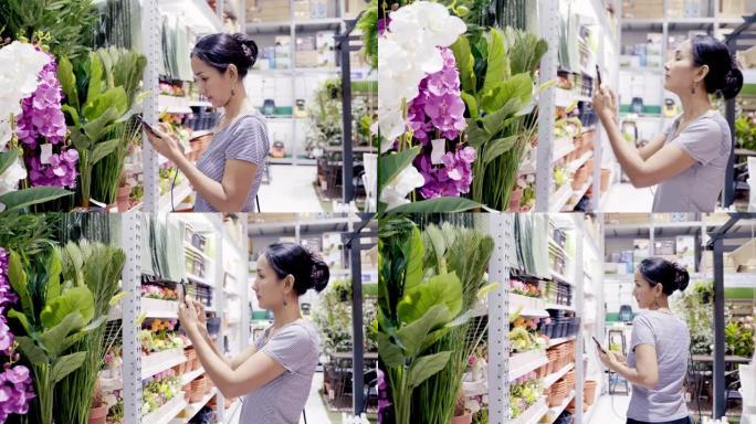 亚洲女性顾客购物，为家居装饰选择鲜花和自拍。亚洲女性在购物商店购买五金和家具。