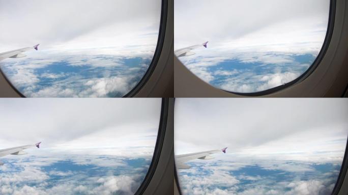 透过飞机的窗户看天空飞行时，飞机机翼会看到多云的景色