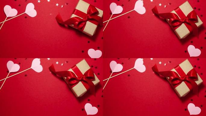 牛皮纸礼品盒，缎面红丝带蝴蝶结和粉色心形平放，红色有复印空间。情人节概念与复制空间