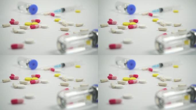 白色背景上的药片、药瓶和注射器。医疗制剂。