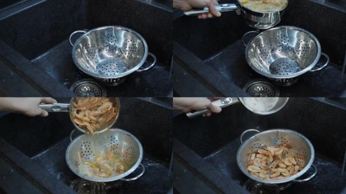 在水槽里洗虾，特写镜头。家庭烹饪。厨师在厨房里煮大虾。虾海沙拉的制备过程。烹饪过程