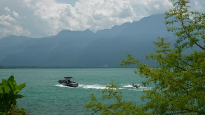 晴天蒙特勒市著名的日内瓦湖湾摩托艇骑行慢动作全景4k瑞士