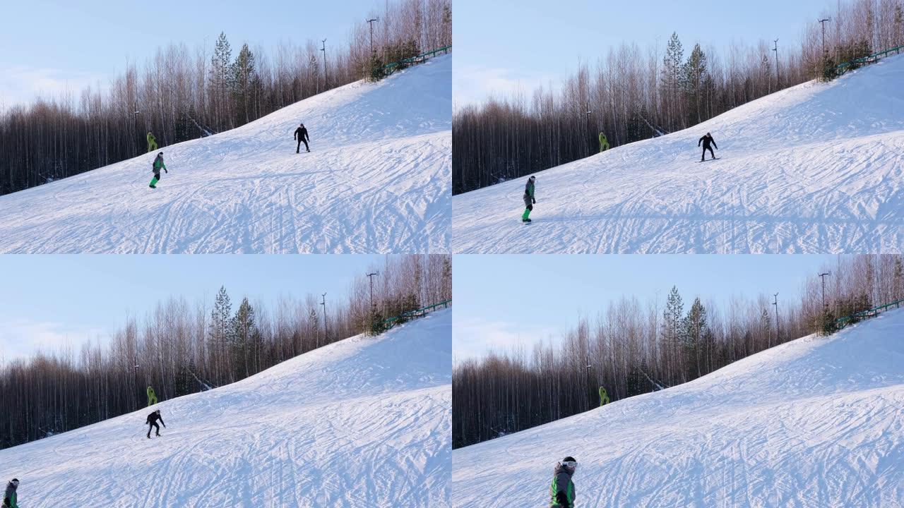 滑雪者和滑雪者在白雪皑皑的冬季山上的滑雪胜地骑行，具有背景风景