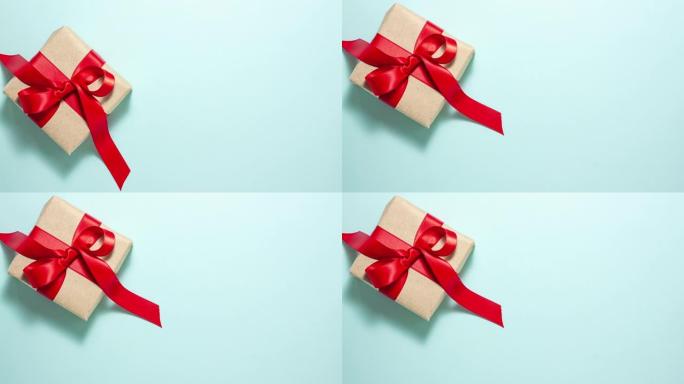 礼品概念。从上面赠送带有红色丝带蝴蝶结的盒子，蓝色有复制空间