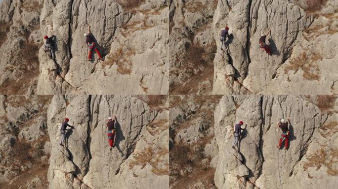 两个人用绳子爬上一块石头。运动攀登，领先。