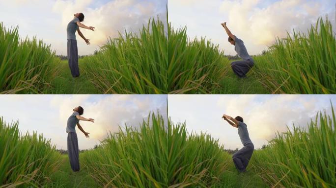 一个年轻人在美丽的稻田上接受瑜伽训练。亚洲旅游概念