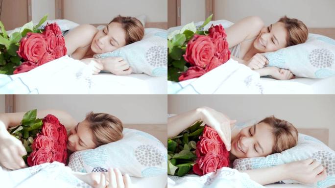 美丽的年轻女子醒来，收到玫瑰花束。床上迷人的女孩很高兴收到礼物。浪漫的概念。