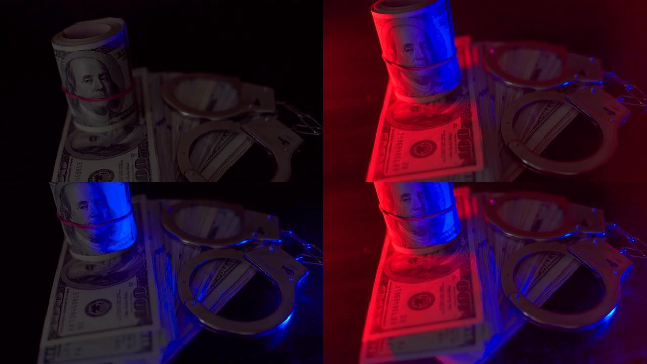 警察闪光。手铐在桌子上，还有很多钱。它们被红色和蓝色的闪光照亮。