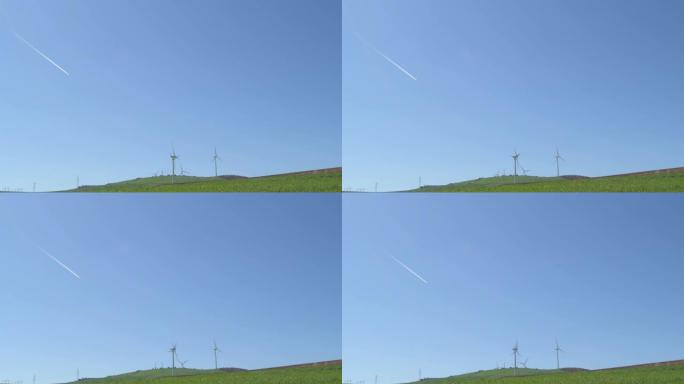晴天的蓝天中带有喷射反应堆的可再生能源风力涡轮机