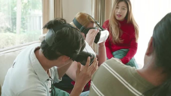 一群年轻的千禧一代在他们公寓的客厅里一起玩虚拟现实玻璃