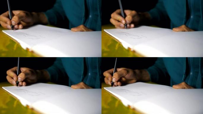 男性手持圆珠笔，在素描本中画出黑线。才华横溢的艺术家的手臂特写在白纸上描绘了美丽的抽象图像。艺术和创