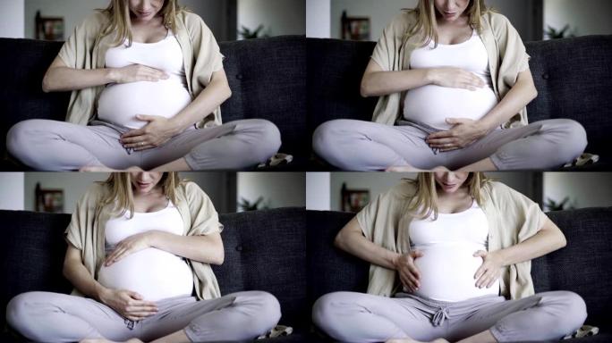 孕妇按摩腹部和说话的前视图