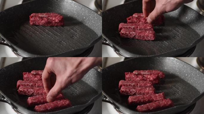 男子将新鲜的红肉烤肉串放入装有热油的煎锅中，在家庭厨房中炸午餐，特写选择性焦点食物概念