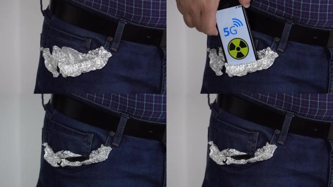 有人将智能手机放在口袋里，上面覆盖着箔纸