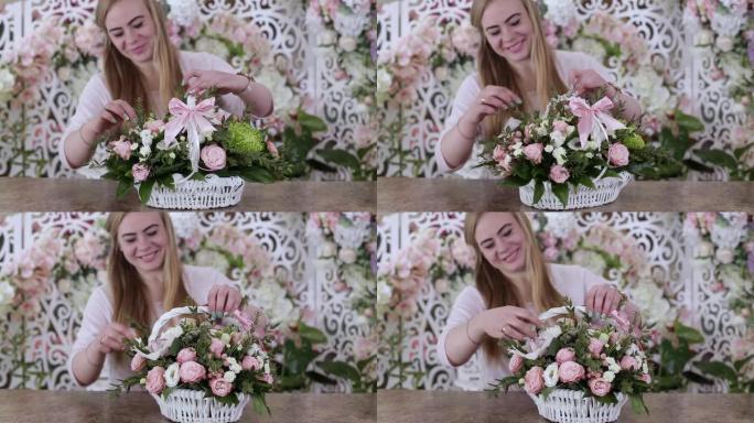 年轻女子花店在白色篮子里制作美丽的玫瑰花花束