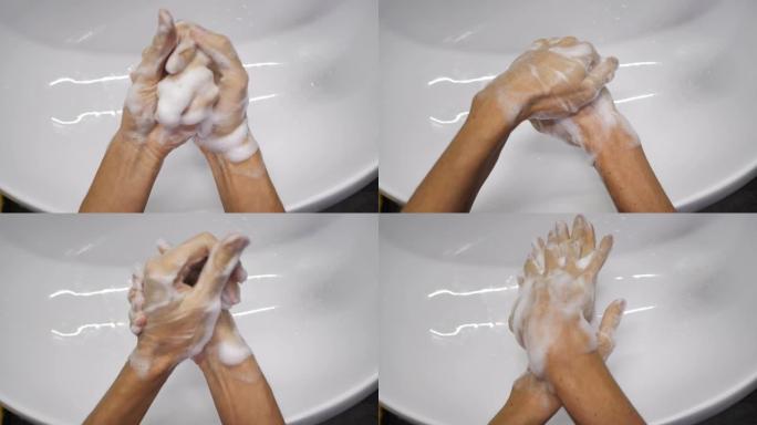 女人正在洗手，以避免被广泛的电晕病毒新型冠状病毒肺炎感染。面目全非的人用抗菌肥皂彻底洗手。4k视频实