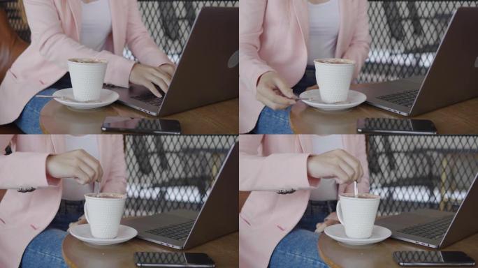 使用笔记本电脑并在咖啡店工作的亚洲女性自由职业者