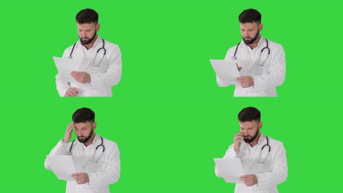 高加索严肃的医生在绿色屏幕上行走并解释心电图，色度键