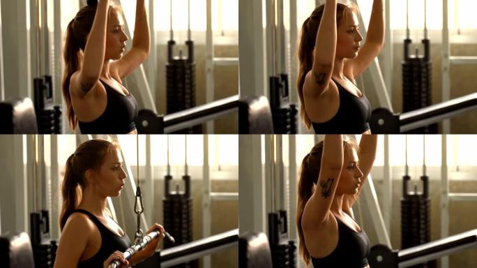 年轻漂亮的女人在健身房锻炼体重训练