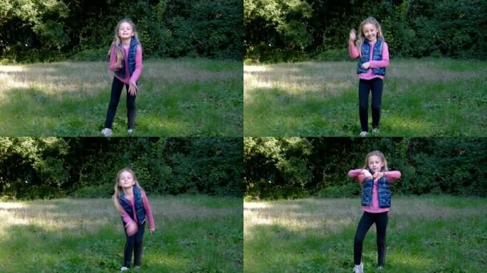 小女孩在春天公园的绿色草坪上表演有趣的舞蹈