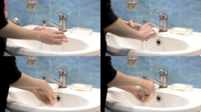 小女孩早上在浴室用肥皂洗手，个人卫生，防止疾病和冠状病毒