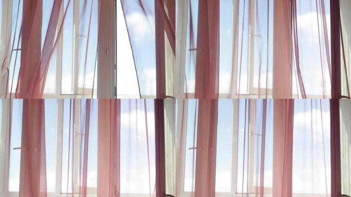 窗户的红色窗帘在风中吹起