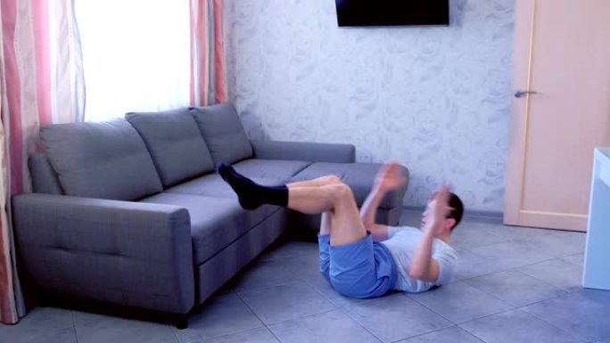 有趣的书呆子正在家里躺在地板上做腹部仰卧起坐运动。运动幽默概念。