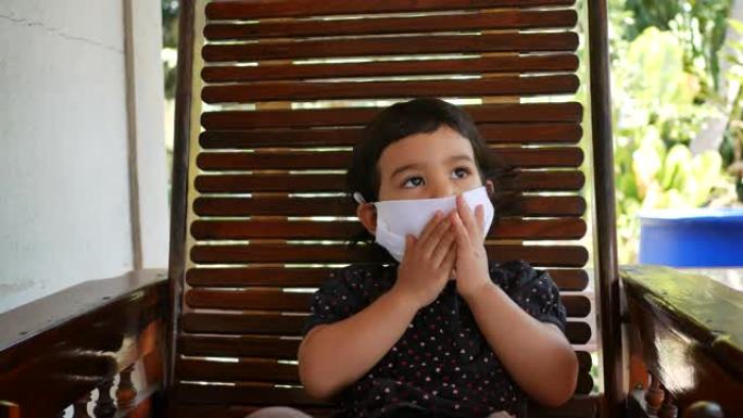 亚洲小女孩戴着流感和病毒保护面具