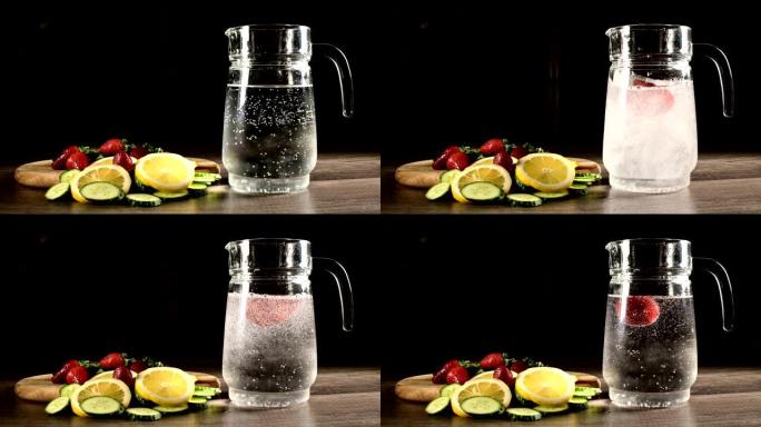 深色背景上的玻璃玻璃瓶，新鲜水果和冷冻草莓，柠檬薄荷和黄瓜在起泡矿泉水中。在苏打水中扔水果
