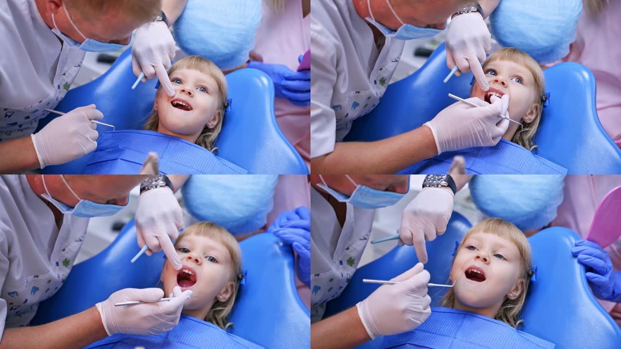 口腔科椅子上的小孩用手指指着病牙