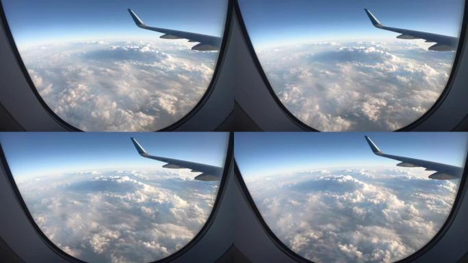 飞机的机翼从窗户飞过飞机的云层