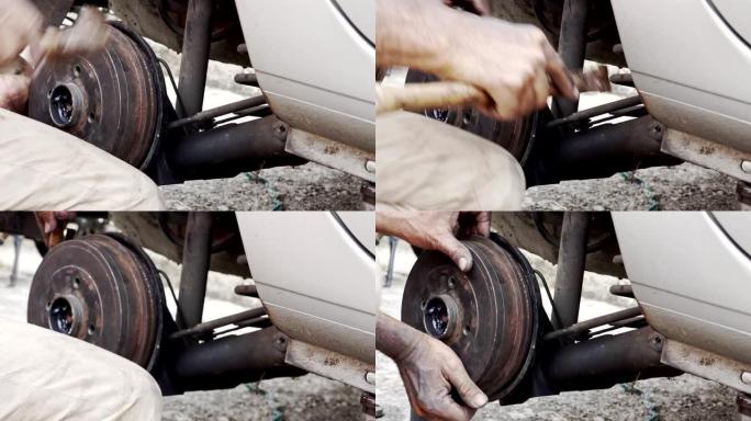 汽车带式制动器修理-西班牙男子拆卸鼓