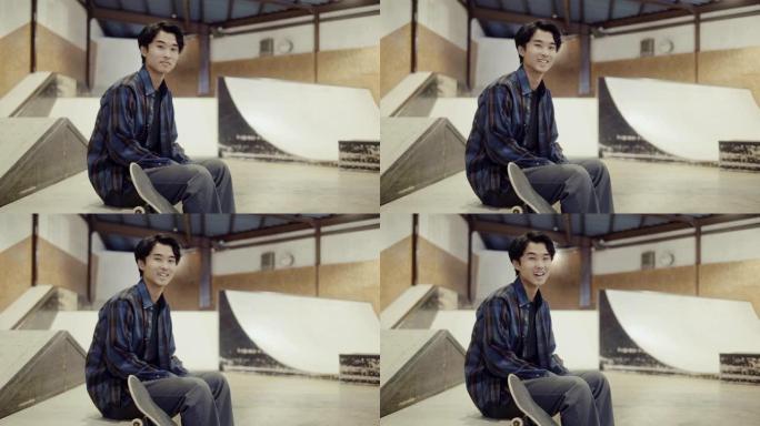 在滑板公园里一个年轻微笑的日本男滑板手的肖像 (慢动作)